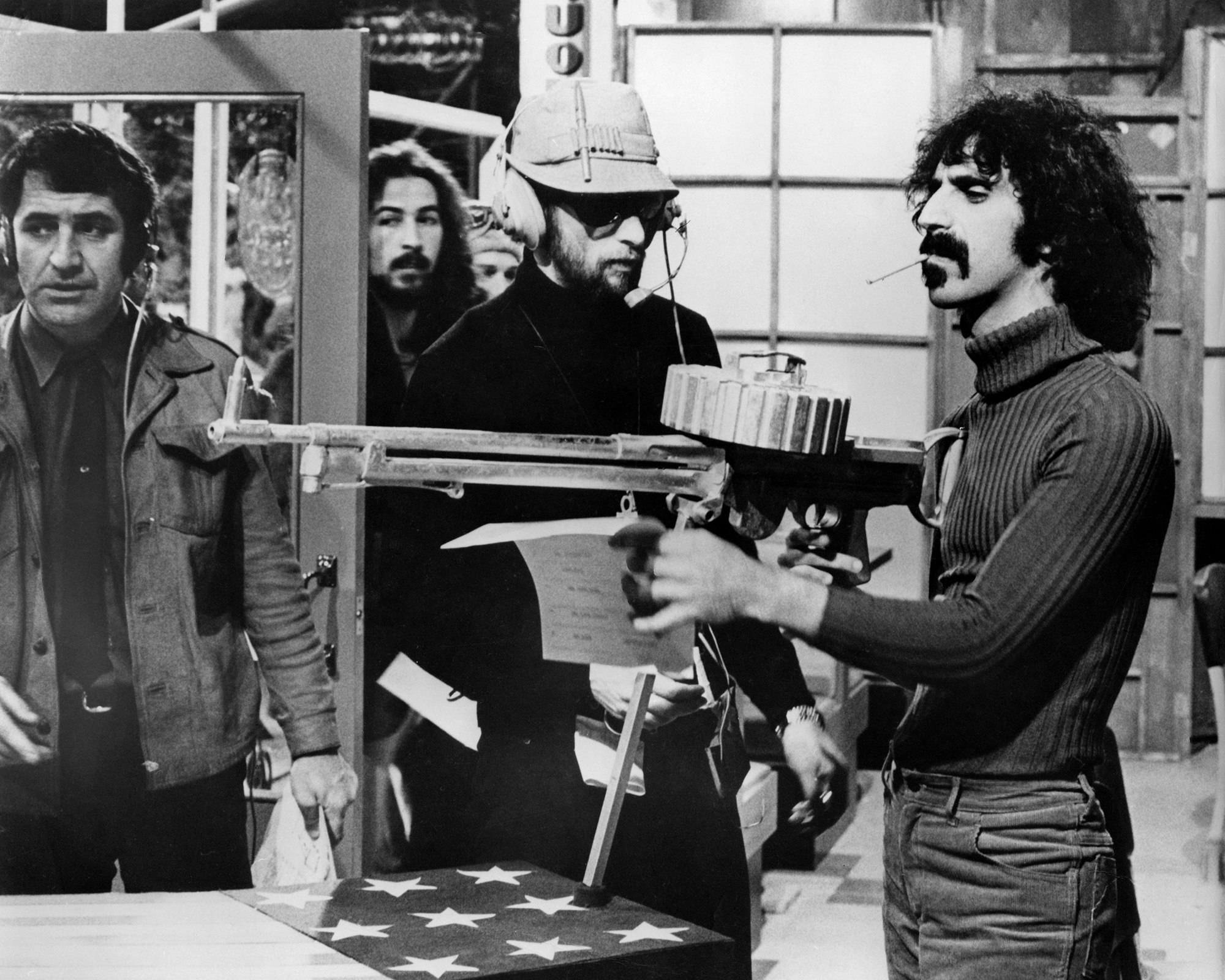 My Way or the Highway: Zappa, with machine gun, on the set of <i>200 Motels</i>, 1971. Photo via Silver Screen Collection/Getty Images.